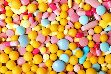 Photo of Heap of many different colorful pills as background