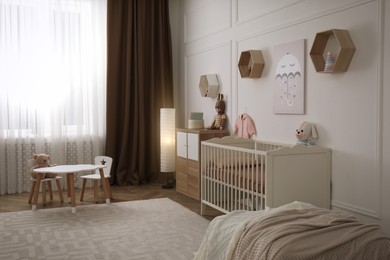 Photo of Modern baby room interior with stylish furniture and toys