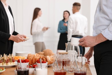 Photo of Coworkers having business lunch in restaurant, closeup