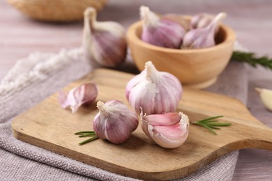 Photo of Bulbs and cloves of fresh garlic on table, closeup