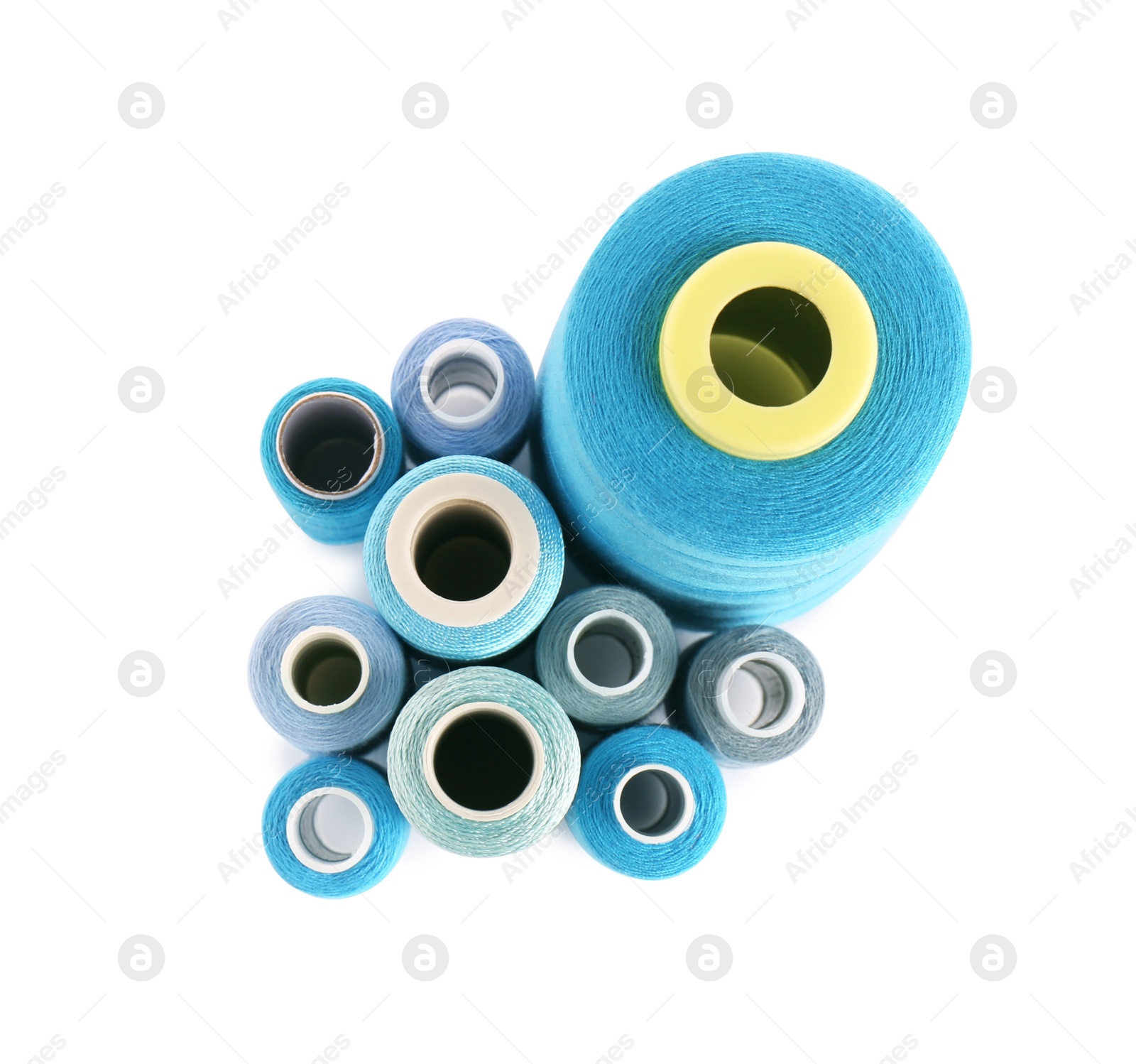 Photo of Set of colorful sewing threads on white background, top view