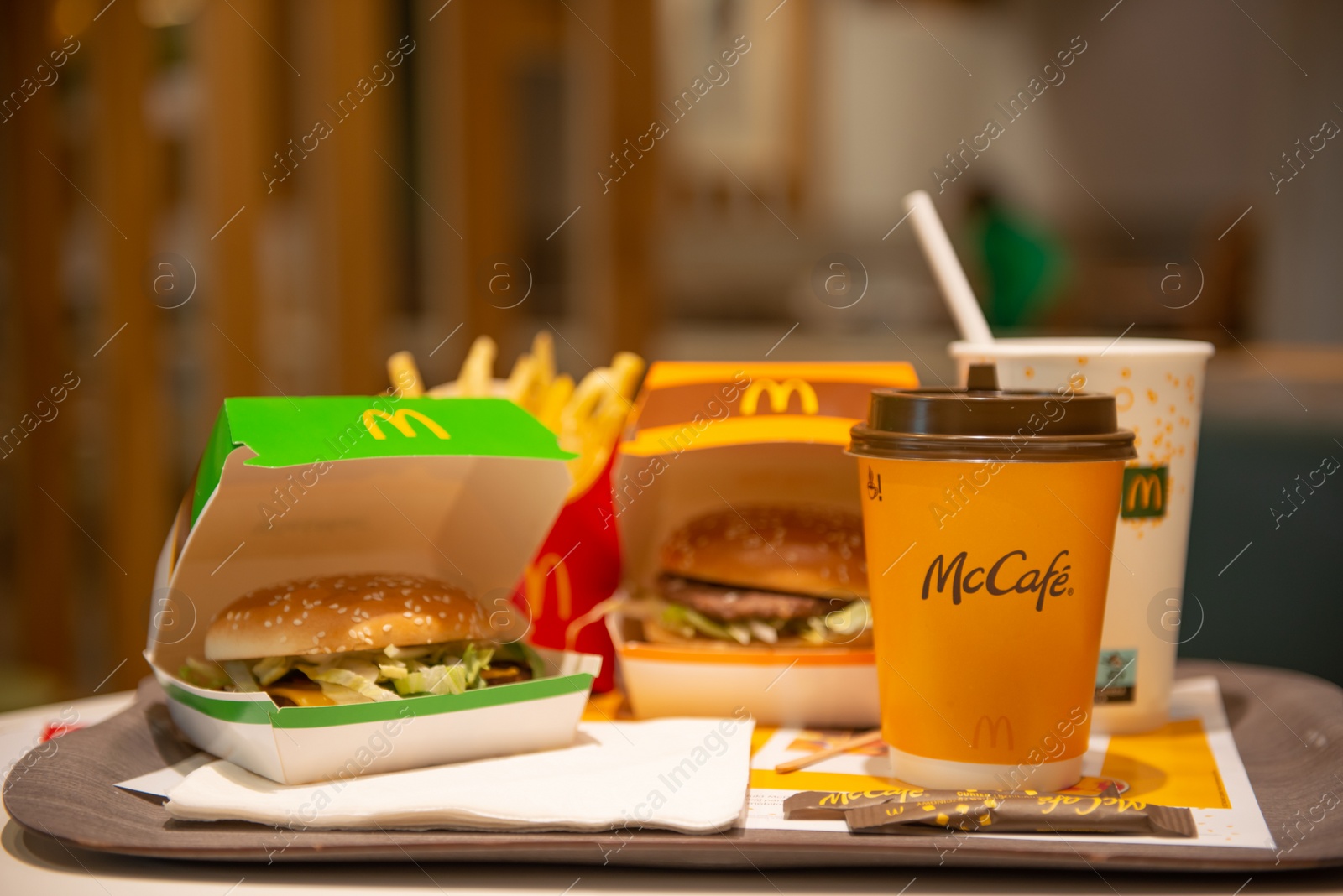 Photo of WARSAW, POLAND - SEPTEMBER 04, 2022: McDonald's French fries, burgers and drinks on table indoors