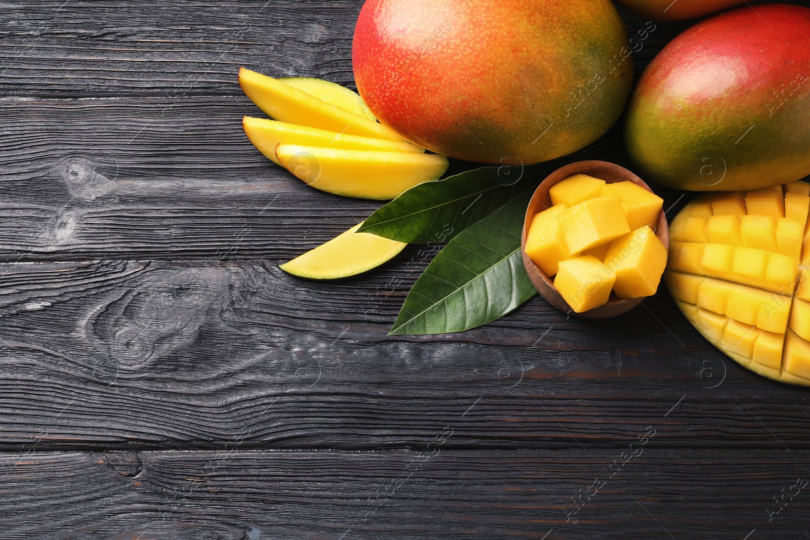 Photo of Flat lay composition with mango on wooden background. Space for text