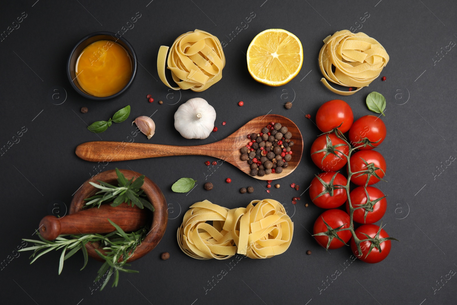 Photo of Flat lay composition with cooking utensils and fresh ingredients on black background