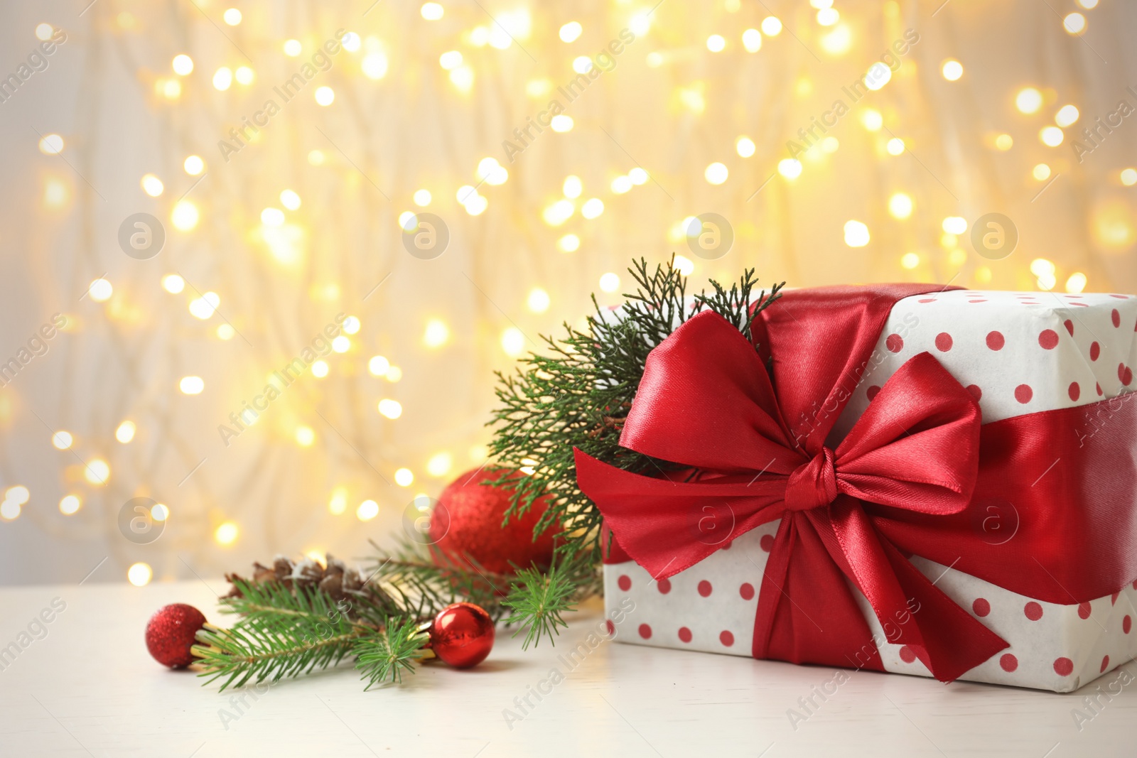 Photo of Christmas gift and decoration on table against blurred background