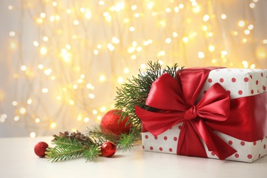 Photo of Christmas gift and decoration on table against blurred background