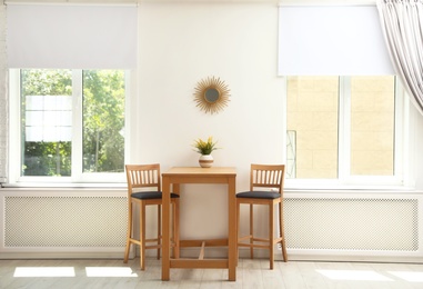 Photo of Modern room interior with wooden dining table