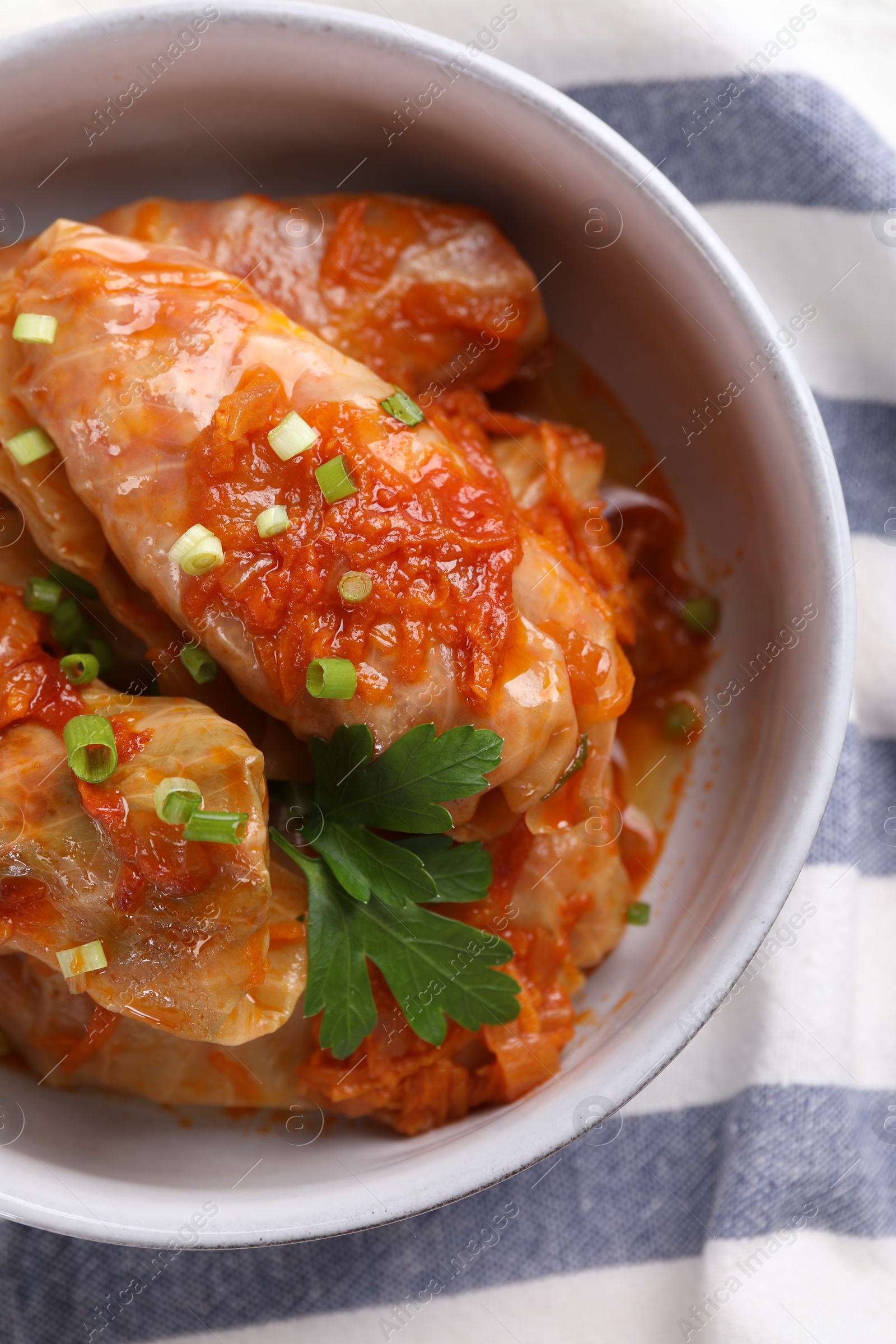 Photo of Delicious stuffed cabbage rolls cooked with homemade tomato sauce on table, top view