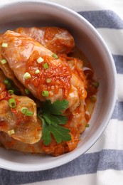 Photo of Delicious stuffed cabbage rolls cooked with homemade tomato sauce on table, top view