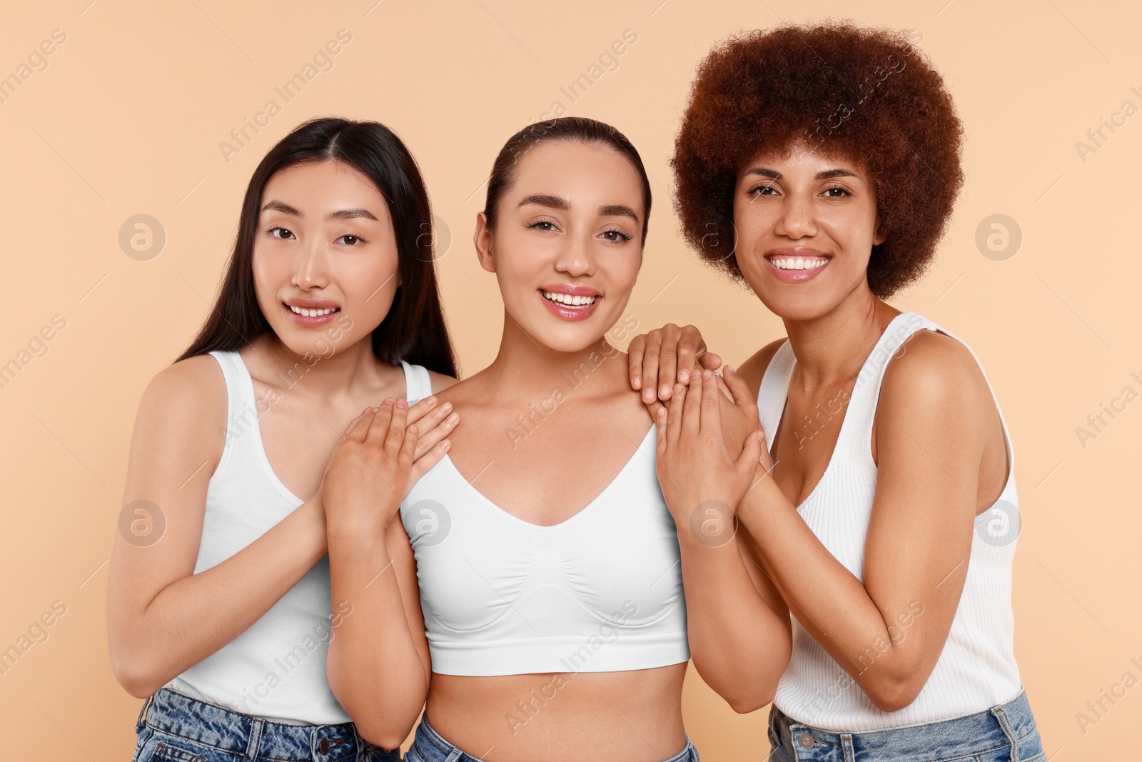 Photo of Portrait of beautiful young women on beige background