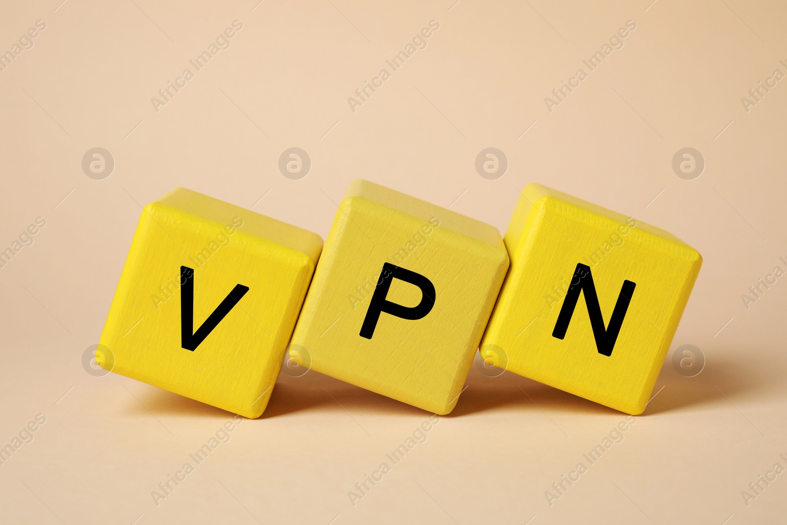 Photo of Yellow cubes with acronym VPN on beige background