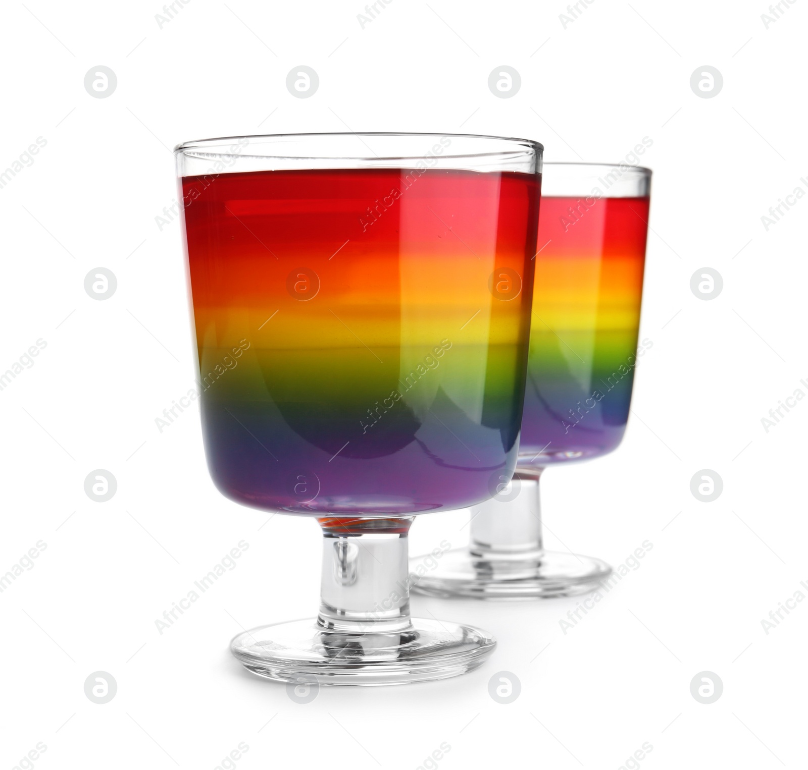 Photo of Tasty layered jelly dessert in glasses on white background