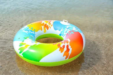 Photo of Bright inflatable ring floating on sea water. Summer vacation