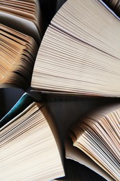 Collection of different books on white shelf, above view