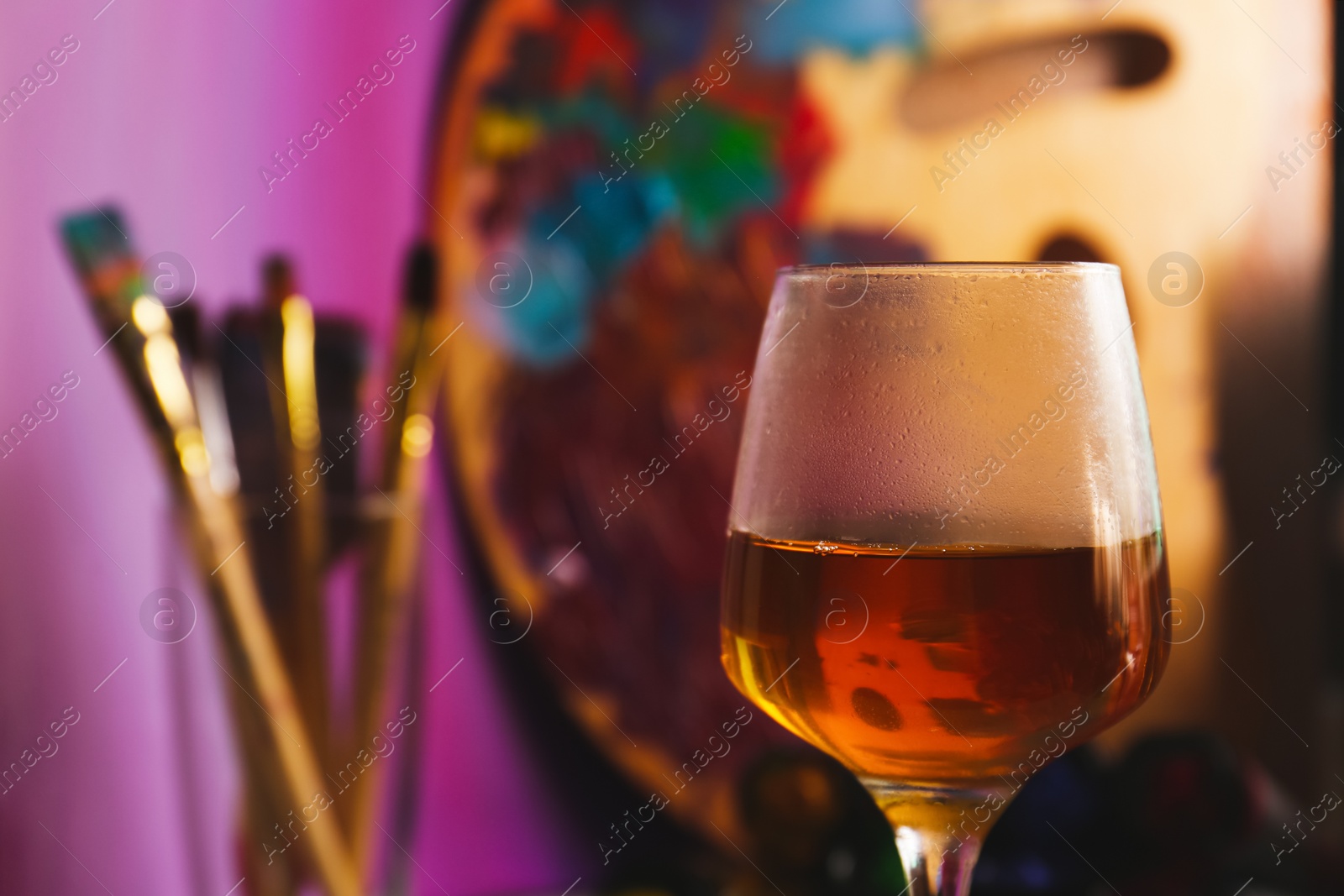Photo of Glass of tasty wine on colorful background, closeup. Space for text