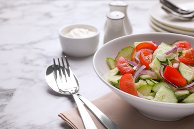 Delicious fresh cucumber tomato salad served on table, space for text