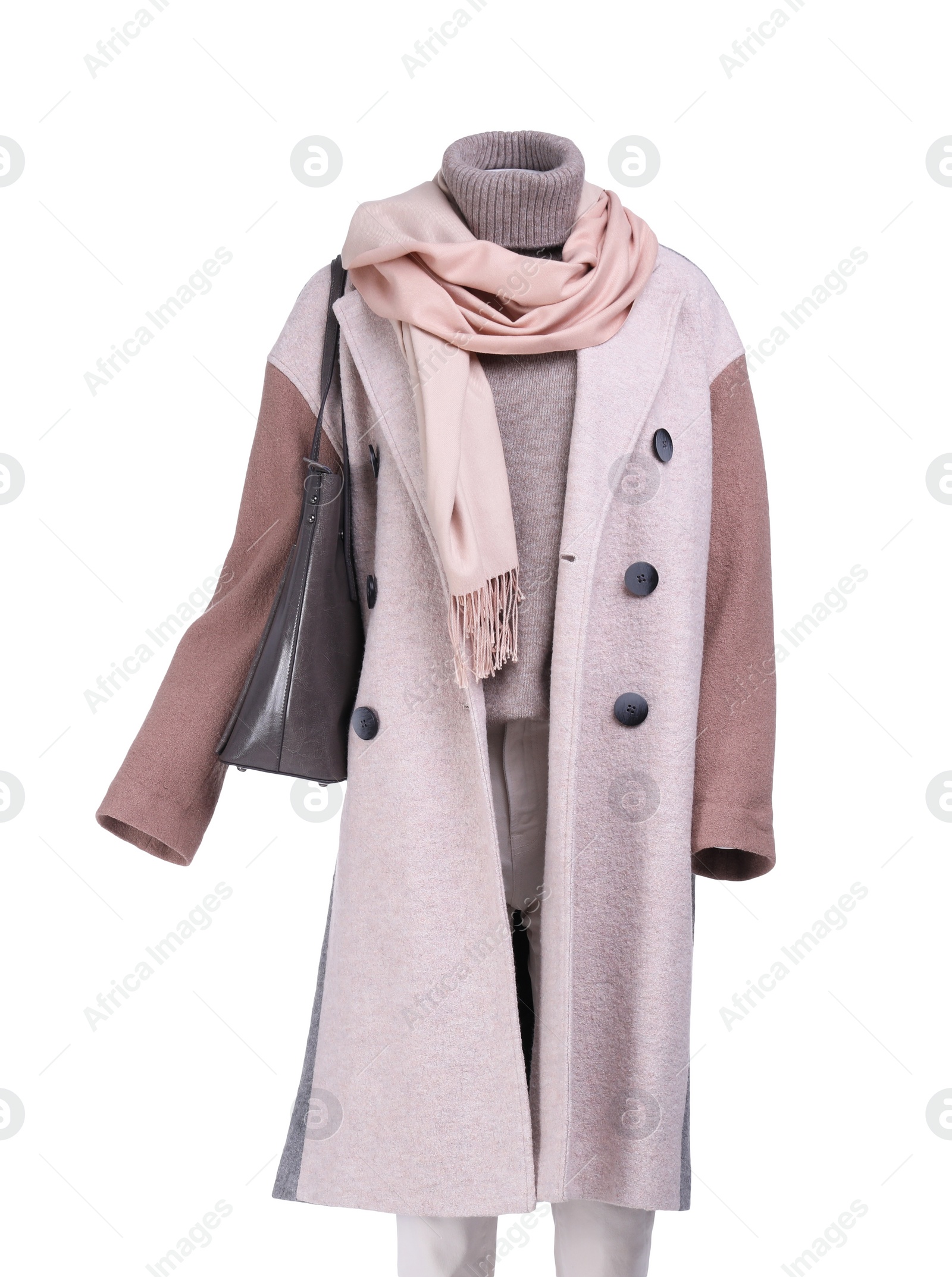 Photo of Female mannequin with accessories dressed in stylish coat, sweater and pants isolated on white
