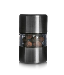 Photo of Manual grinder with allspice peppercorns on white background