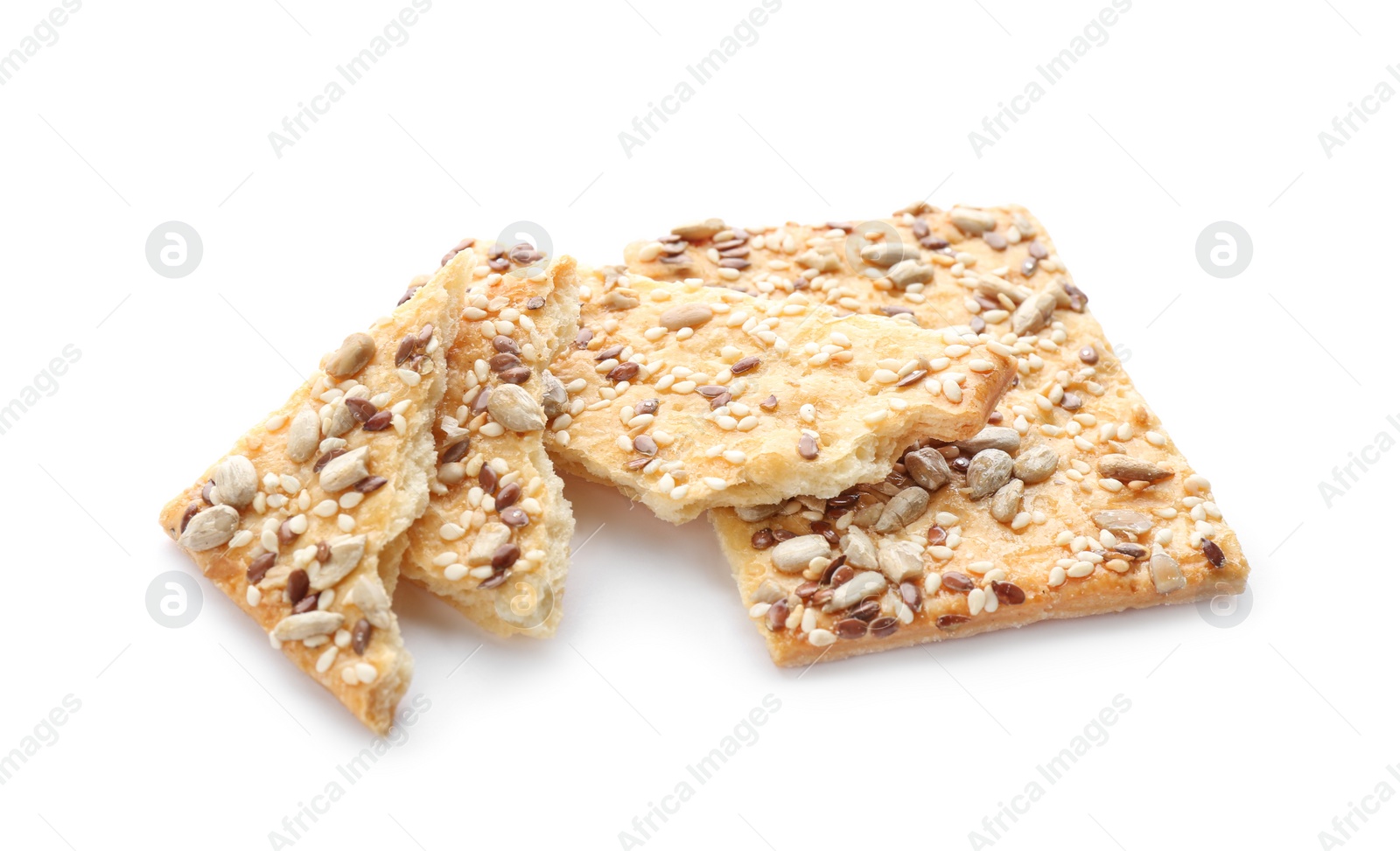 Photo of Broken crispy crackers with different seeds isolated on white