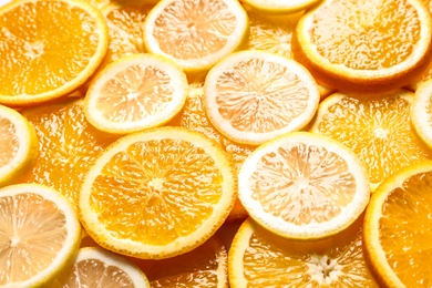 Photo of Slices of fresh citrus fruits as background