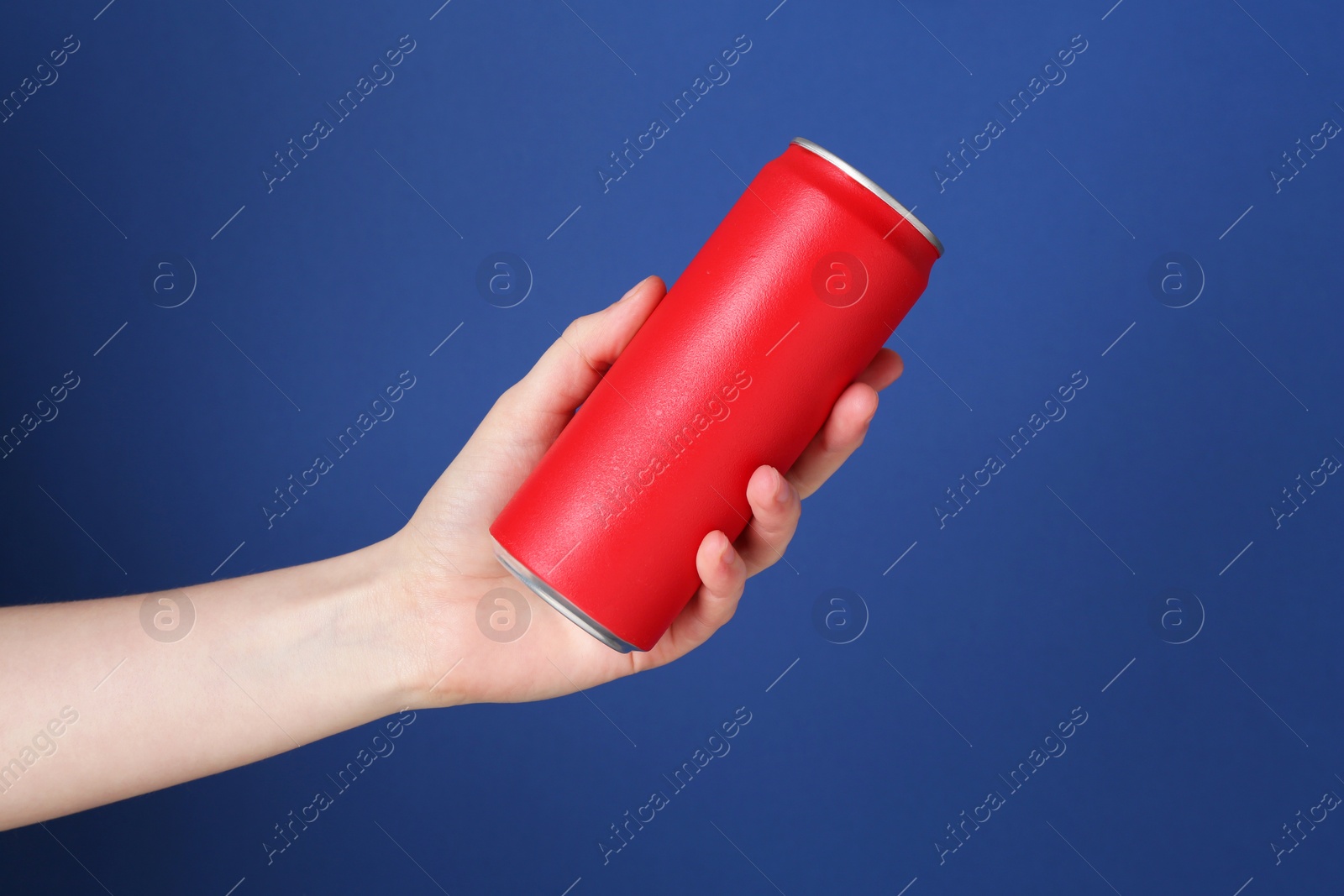 Photo of Woman with energy drink on blue background, closeup