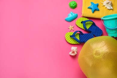 Photo of Flat lay composition with beach ball and sand toys on pink background, space for text