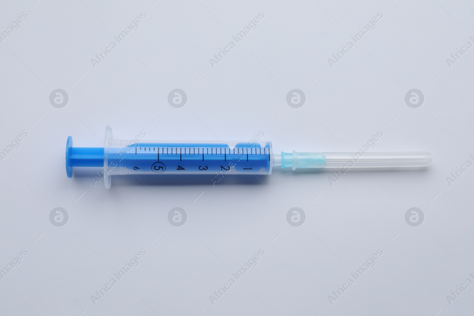 Photo of Disposable syringe with needle isolated on white, top view