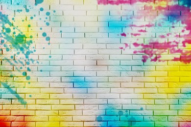 Image of Abstract colorful graffiti drawn on white brick wall