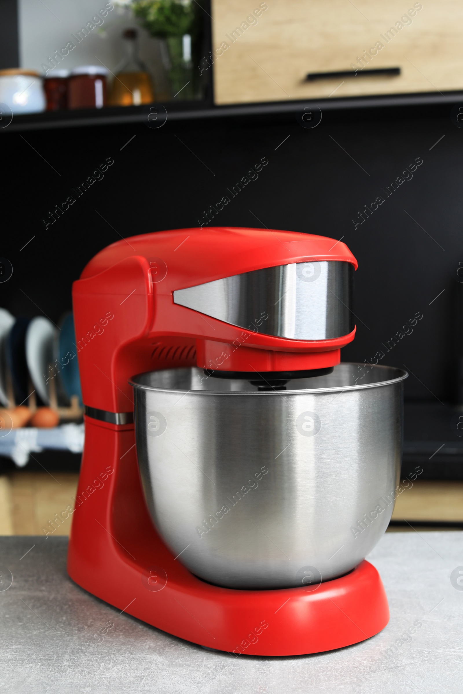 Photo of Modern stand mixer on table in kitchen. Home appliance