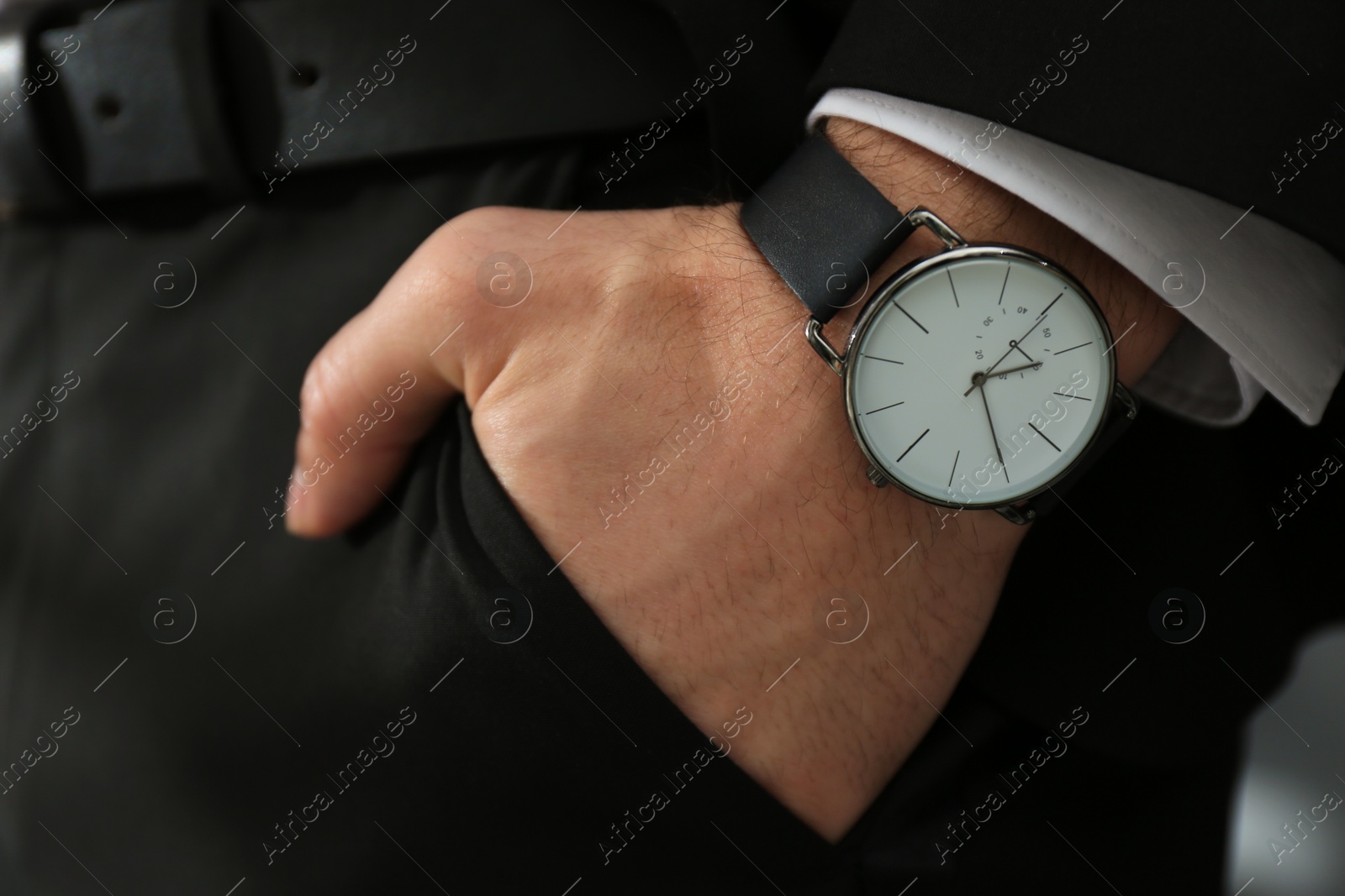 Photo of Businessman in suit with luxury wrist watch, closeup