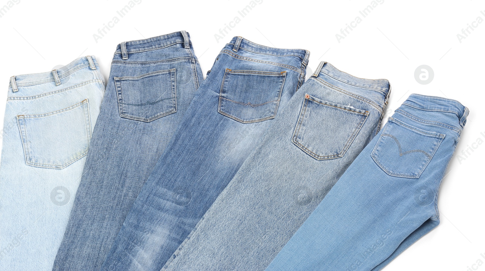 Photo of Different stylish jeans isolated on white, above view