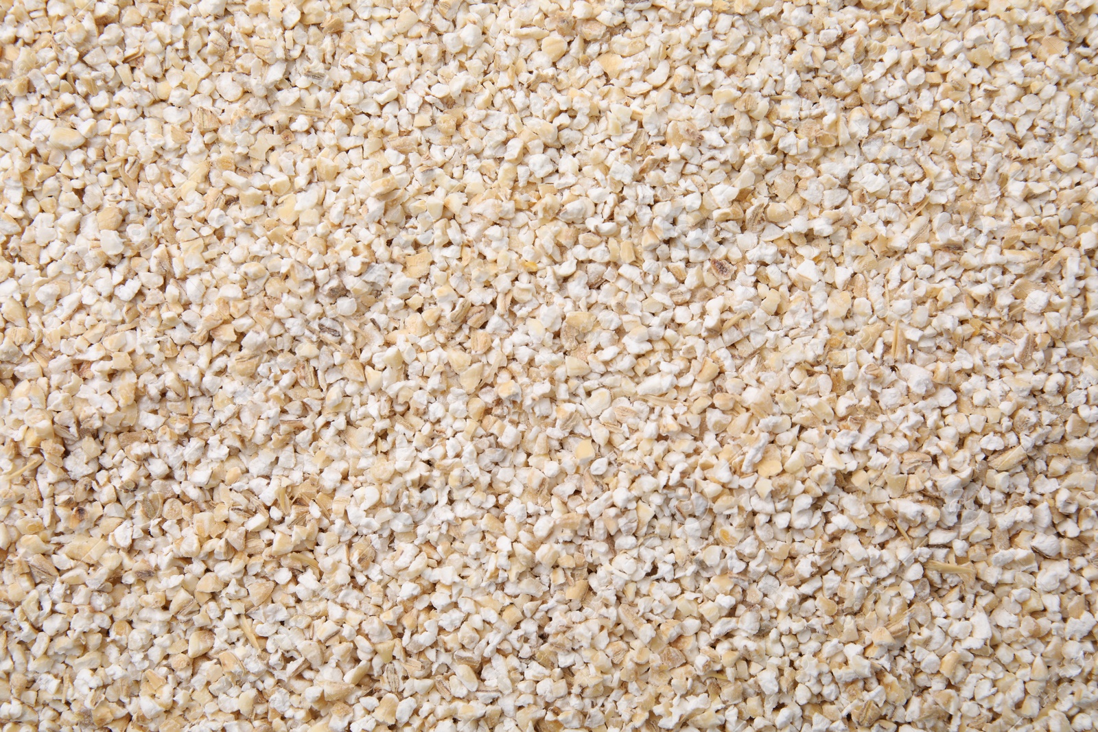 Photo of Raw barley groats as background, top view