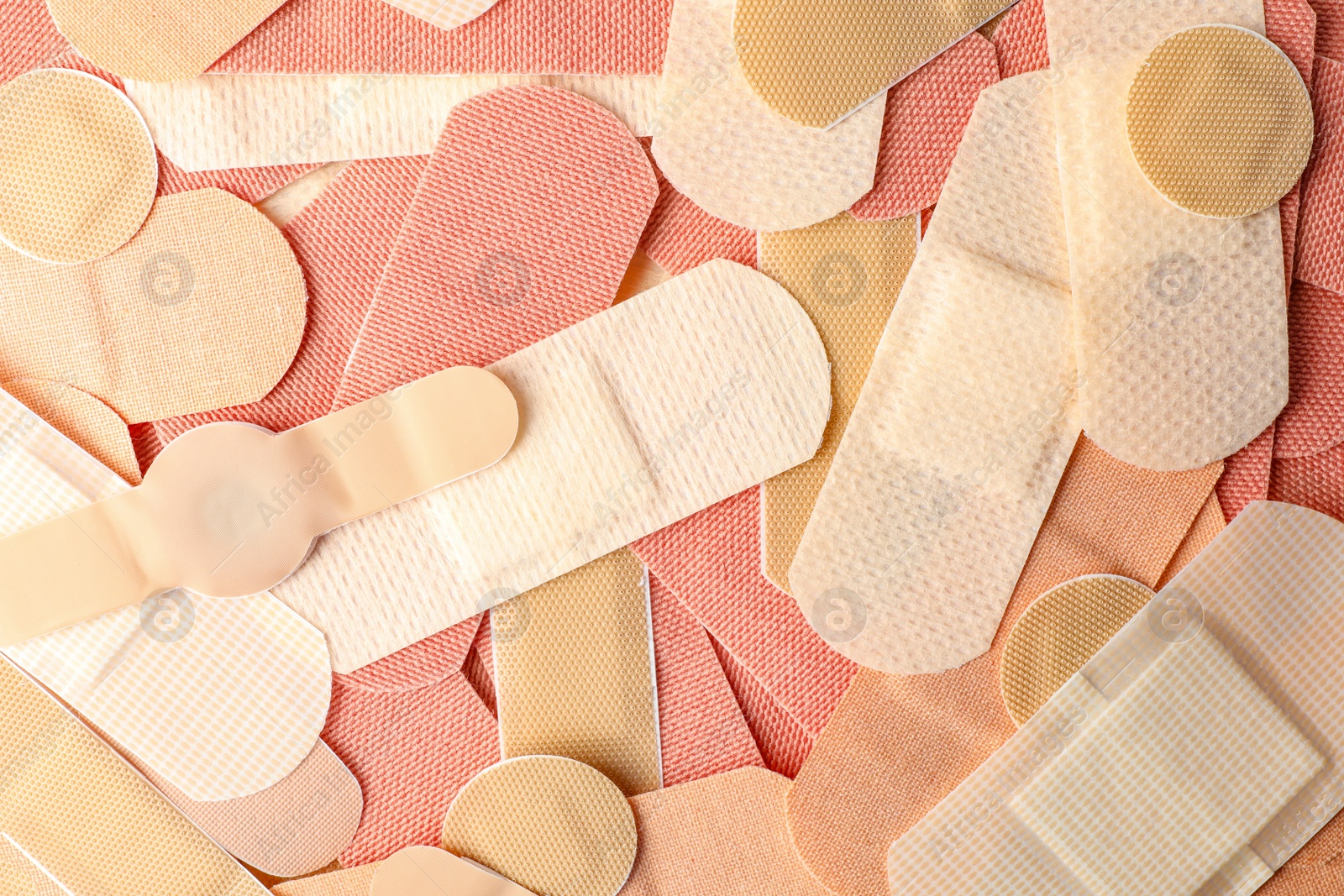 Different medical sticking plasters as background, closeup. First aid item Photo of Different medical sticking plasters as background, closeup. First aid item