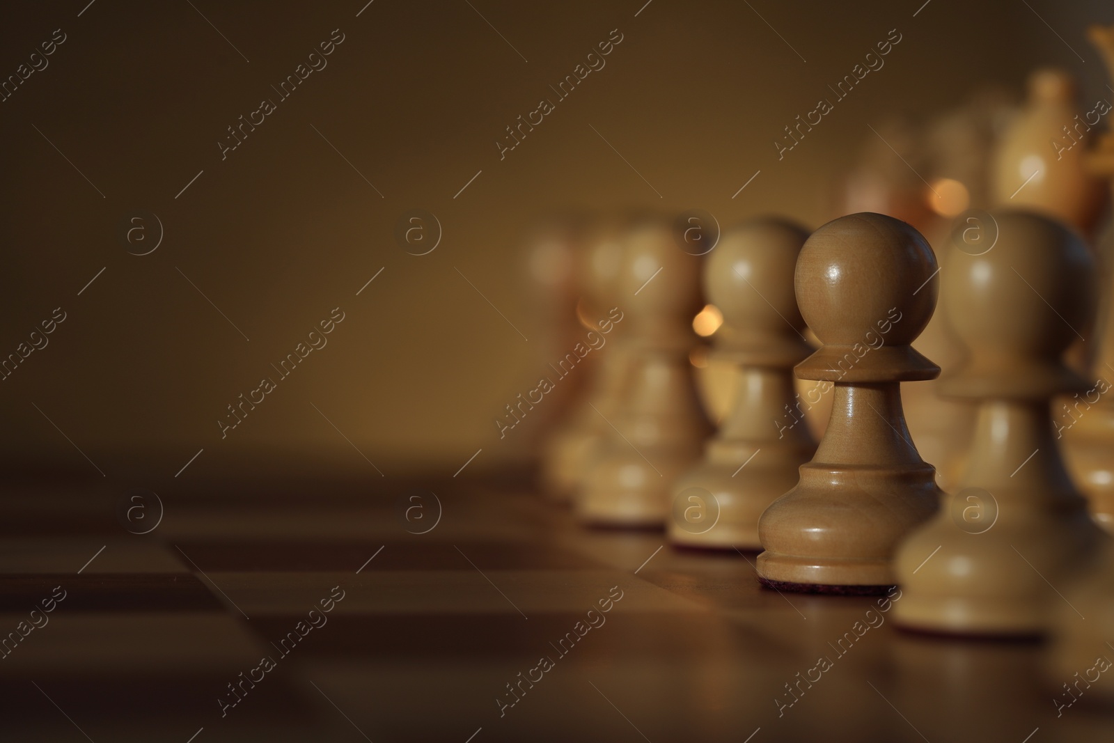 Photo of Wooden chess pieces on checkerboard before game, selective focus. Space for text