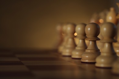 Wooden chess pieces on checkerboard before game, selective focus. Space for text