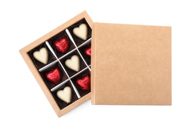 Tasty heart shaped chocolate candies in box on white background, top view. Valentine's day celebration