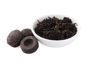 Photo of Cake shaped traditional Chinese pu-erh tea and leaves isolated on white