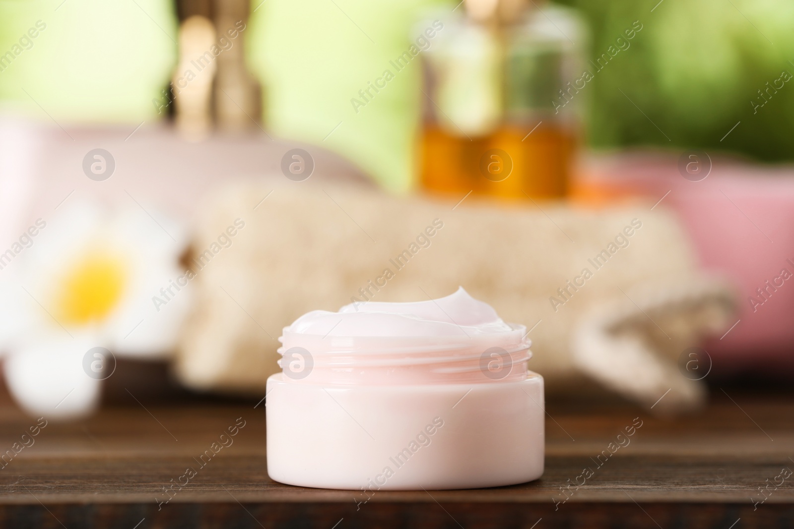 Photo of Jar of body care product on table against blurred background. Space for text