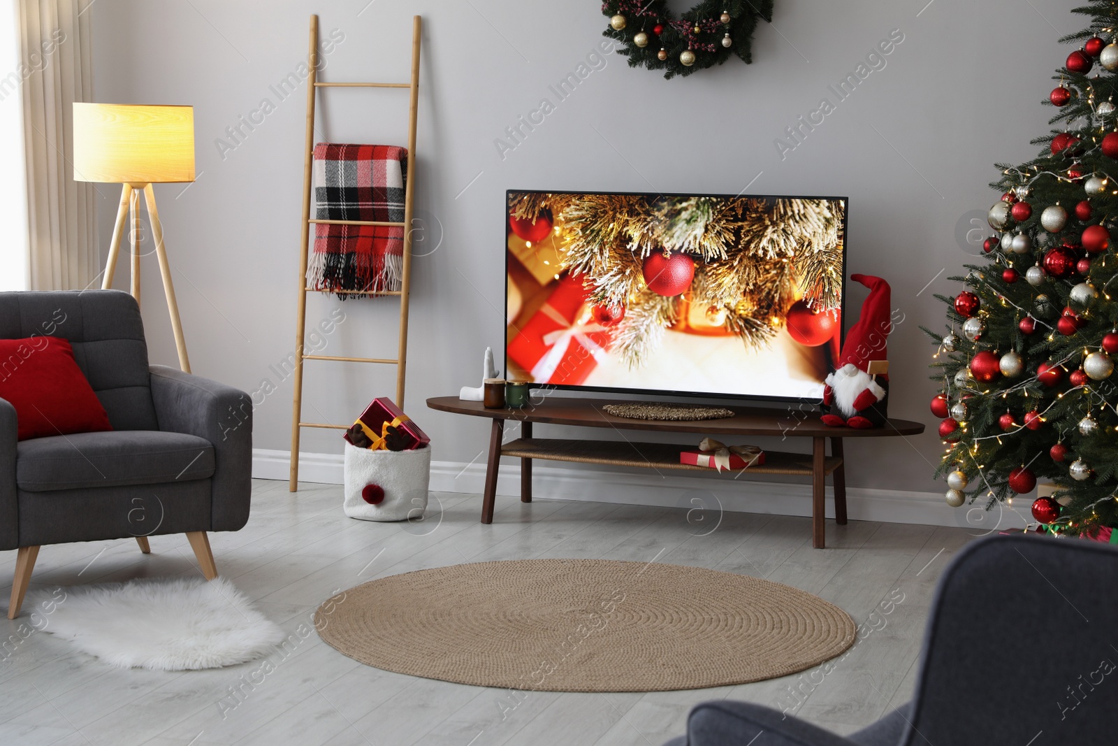 Photo of Stylish living room interior with modern TV and Christmas tree