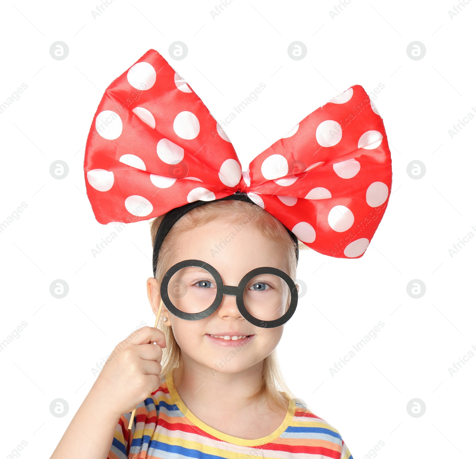 Photo of Little girl with large bow and funny glasses on white background. April fool's day