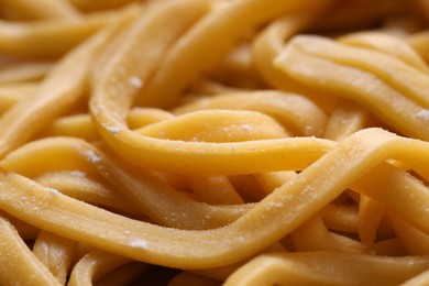 Photo of Raw homemade pasta as background, closeup view