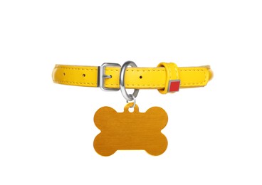 Yellow leather dog collar with bone shaped tag isolated on white