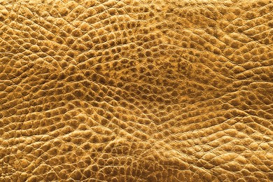 Image of Golden textured surface as background, closeup view