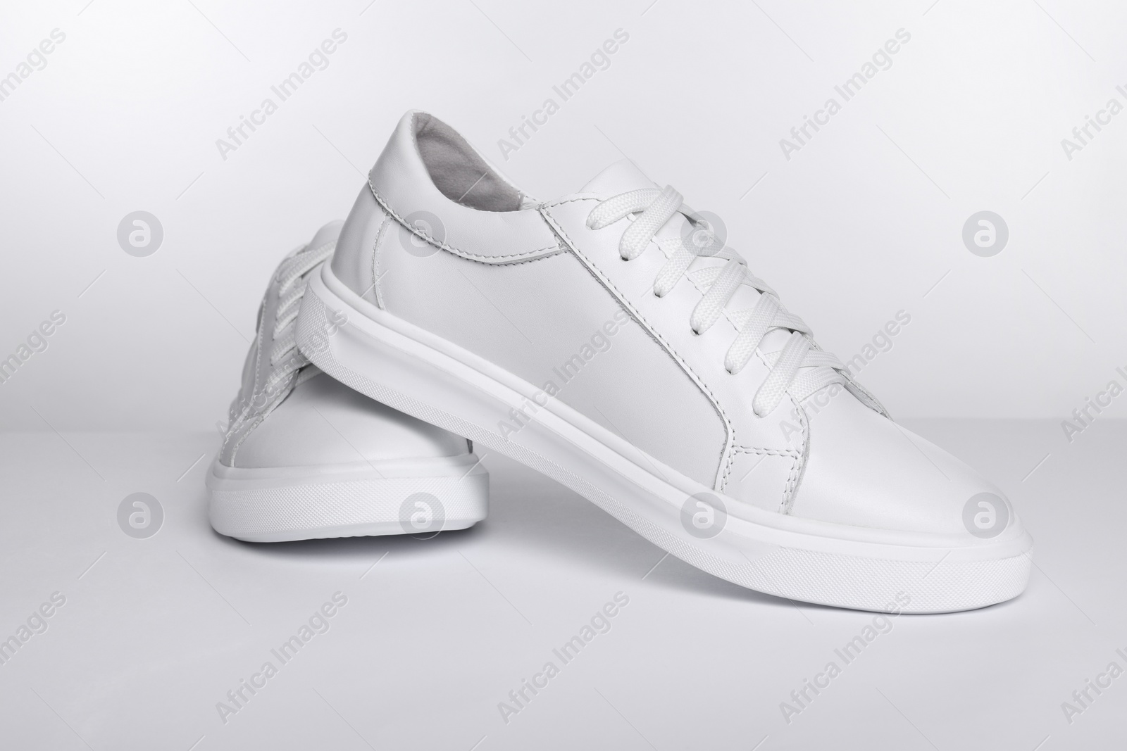 Photo of Pair of stylish sneakers isolated on white