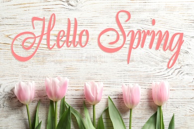 Image of Hello Spring. Beautiful tulips on white wooden background, flat lay