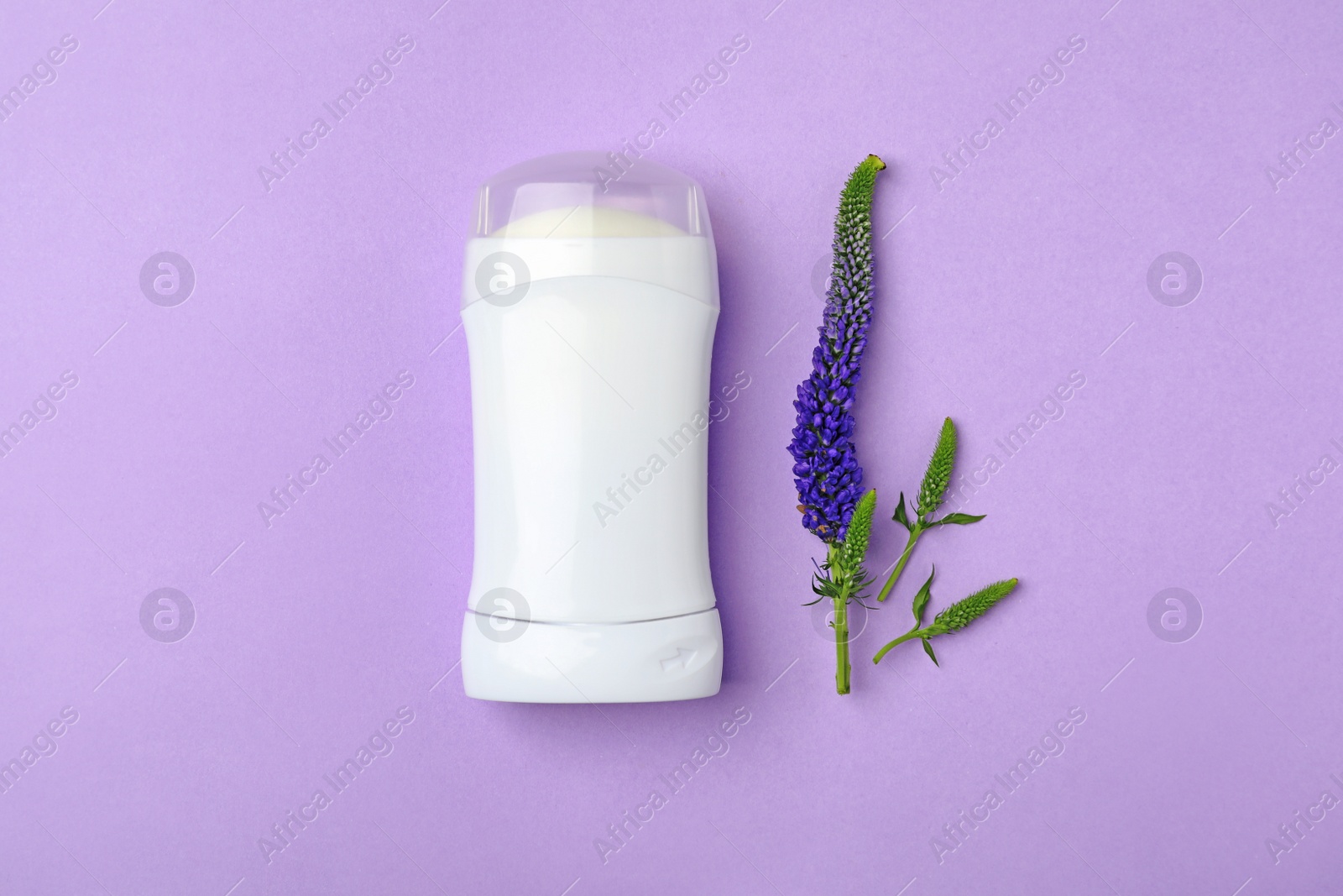 Photo of Deodorant and flower on color background, top view