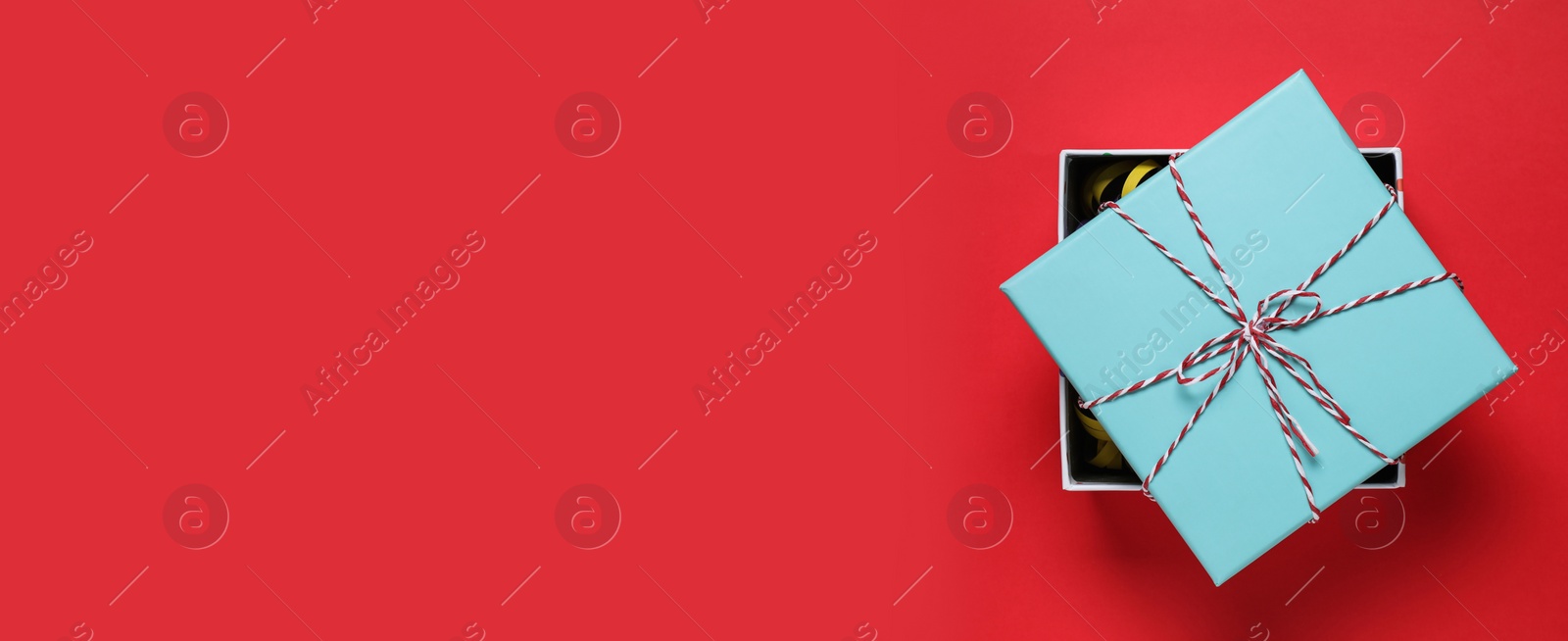 Image of Beautiful gift box and space for text on red background, top view. Banner design