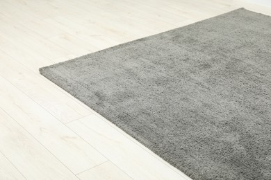 Soft grey carpet on white laminated floor indoors