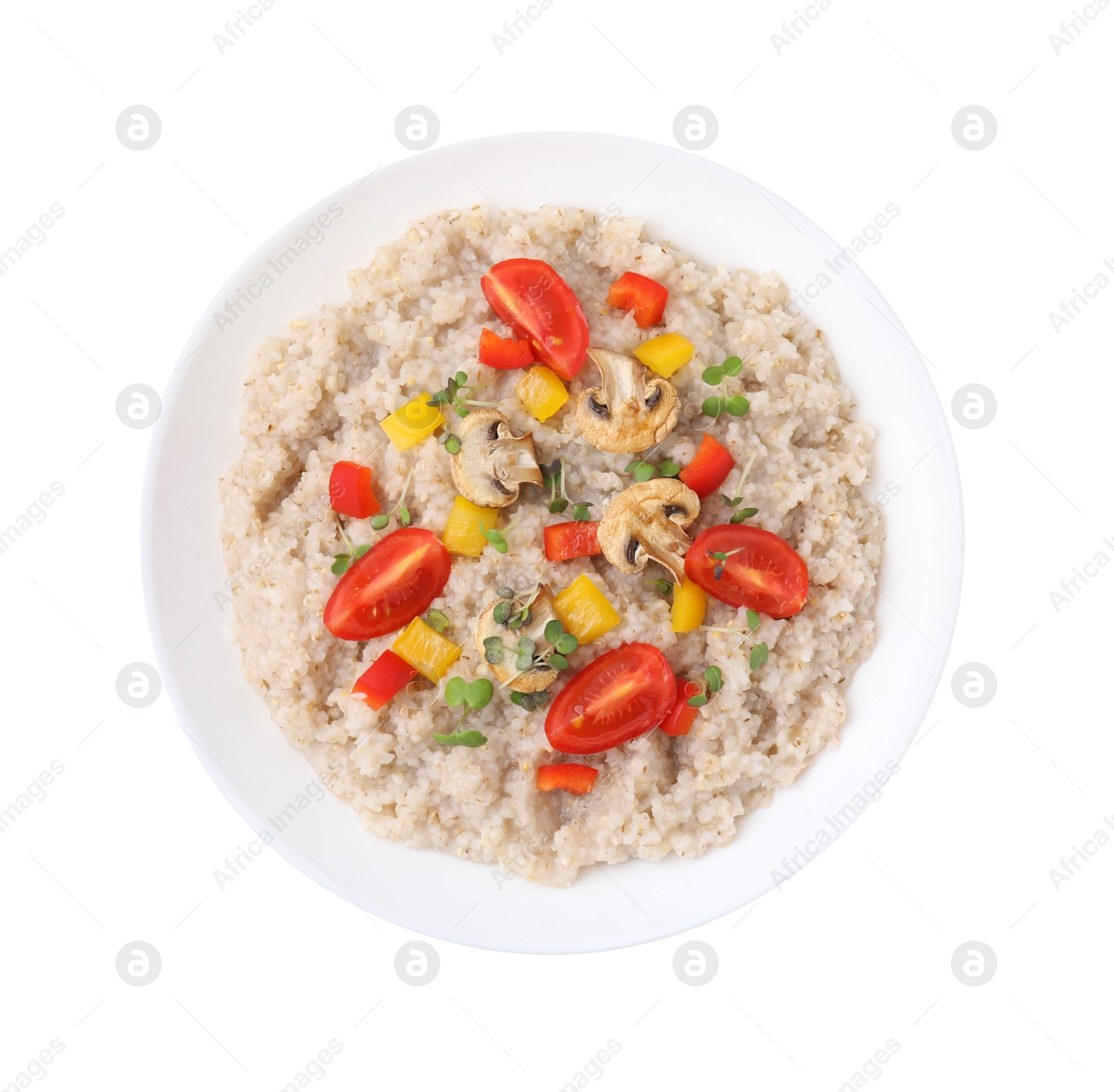 Photo of Delicious barley porridge with vegetables and microgreens in bowl isolated on white, top view