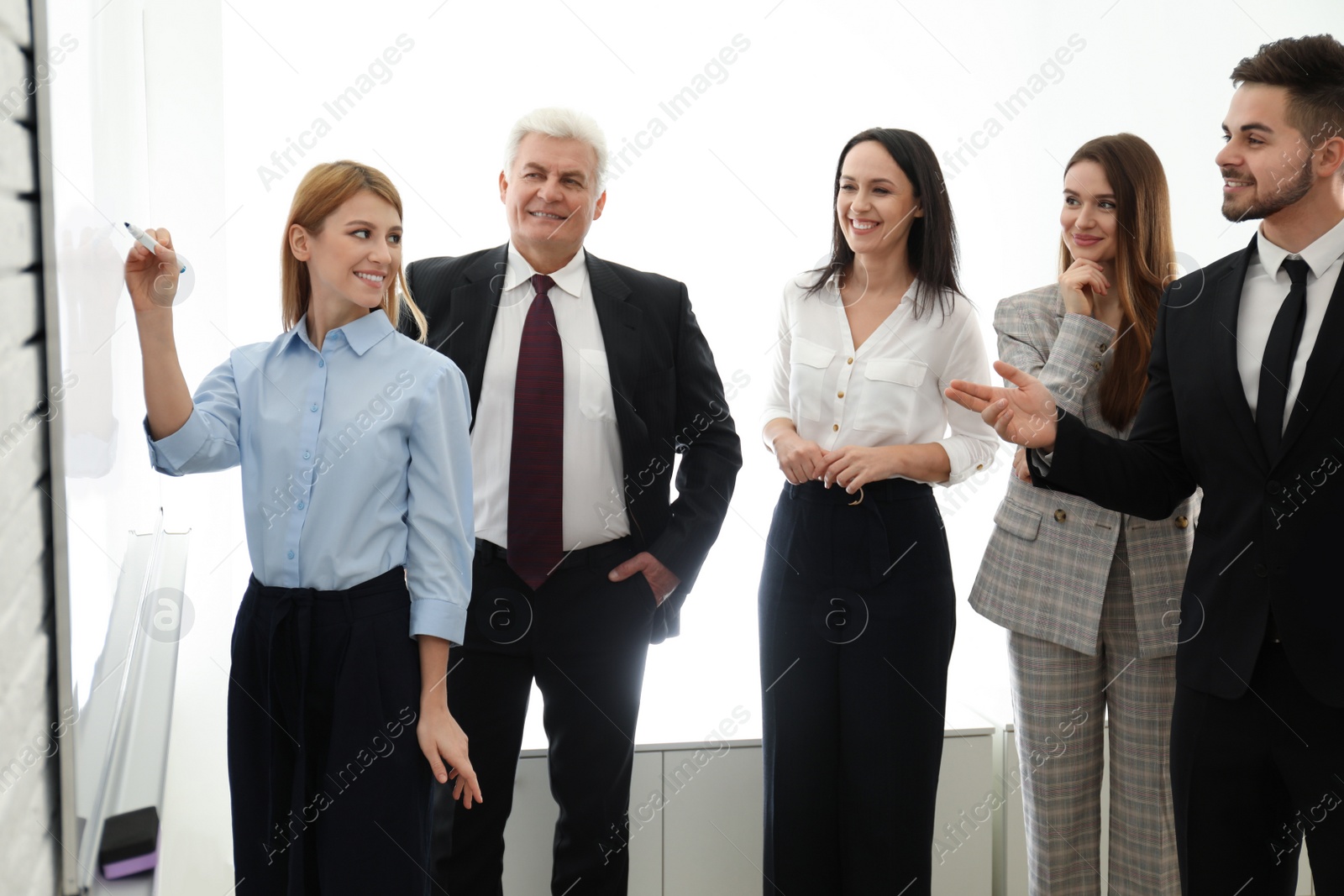 Photo of Professional business trainer working with people in office